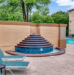 A small pool with steps leading to it.