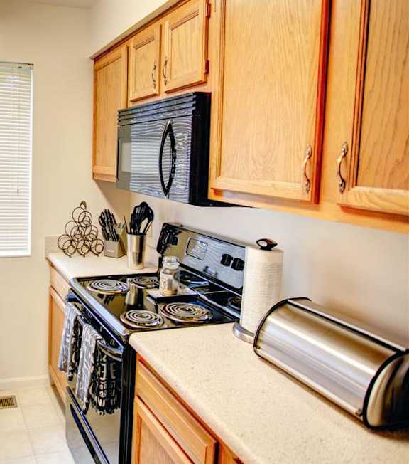 a kitchen with a stove top oven and a sink