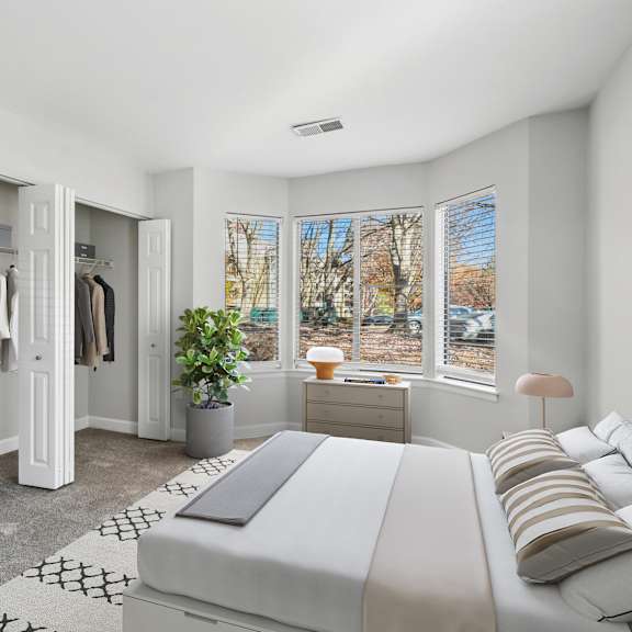 A bedroom with a large bed and a wardrobe.