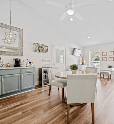 A modern kitchen with a dining table and chairs.