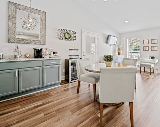 A modern kitchen with a dining table and chairs. at Brandemere Apartment Homes, Winston Salem, 27106