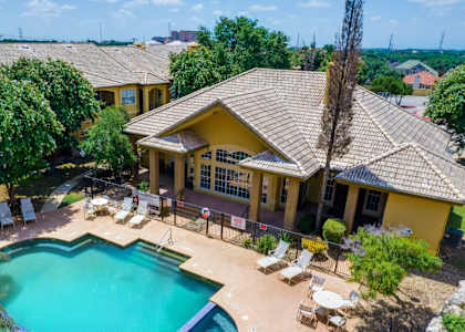 a aerial view of a pool and a house