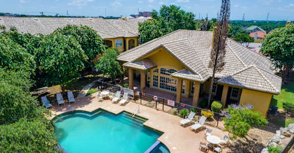 a aerial view of a pool and a house