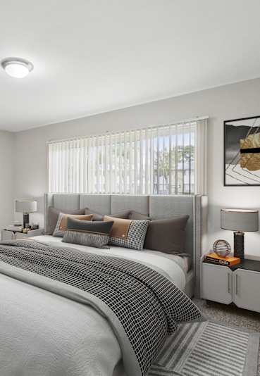 A bedroom with a large bed and two nightstands.