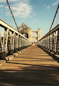 A long metal bridge with a wooden walkway.