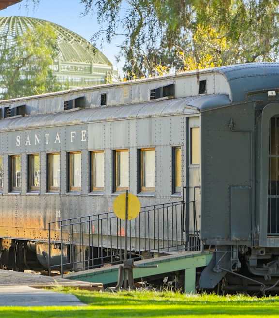 A Santa Fe train car is parked on the tracks.