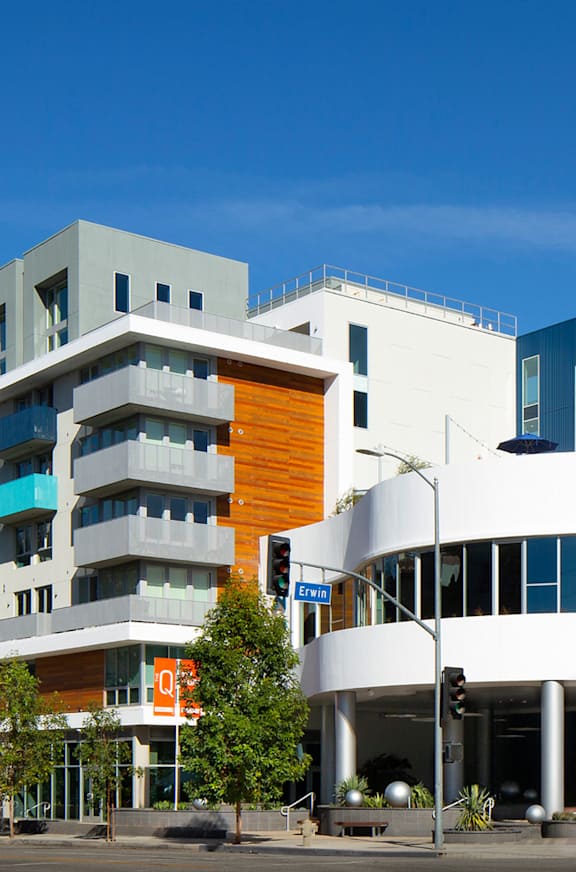 A modern building with a white and orange facade.