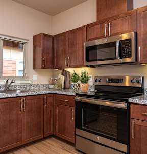 a kitchen with stainless steel appliances and granite counter tops