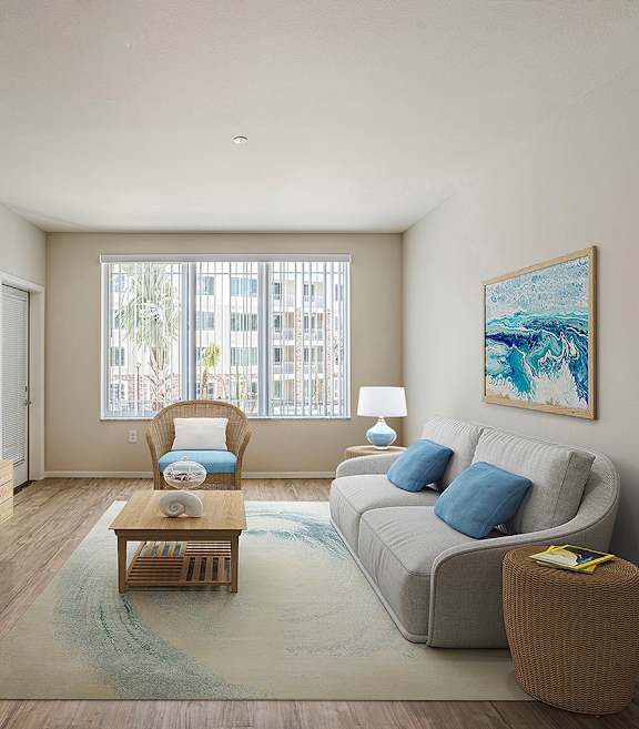 A living room with a grey couch, a wooden cabinet, a coffee table, and a painting on the wall.