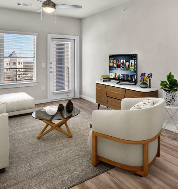 a living room with a couch and a chair and a tv