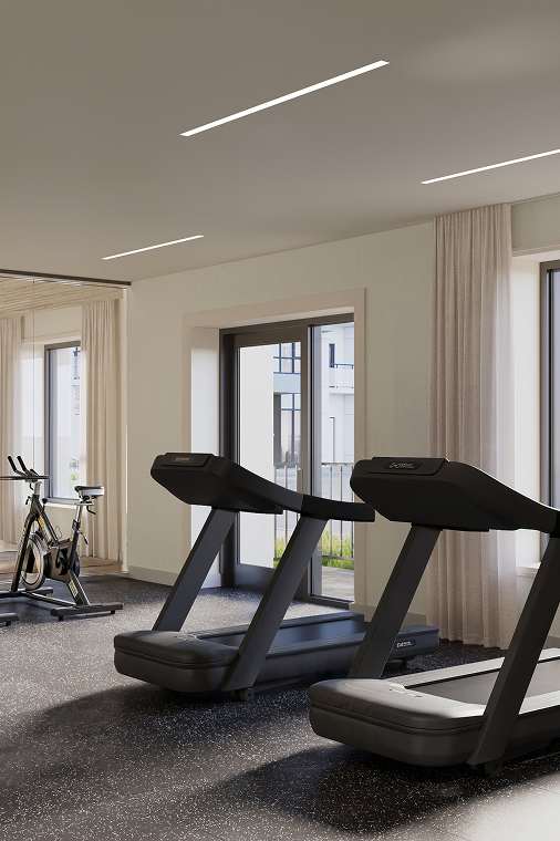 A gym with treadmills, exercise bikes and a view of the outside. at Roxy Apartments, Hamilton, ON, L8H 0B7