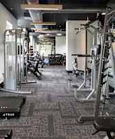 A gym with treadmills and elliptical machines.