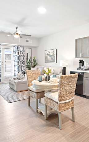 A kitchen with a dining table and chairs.