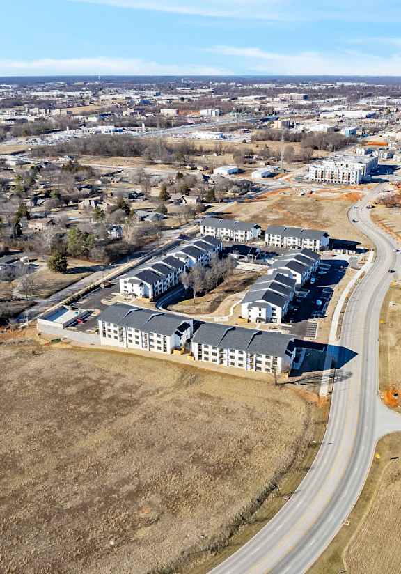 A large building complex is under construction in a rural area.
