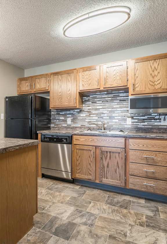 Two-bedroom apartment with a kitchen featuring warm wood finishes.