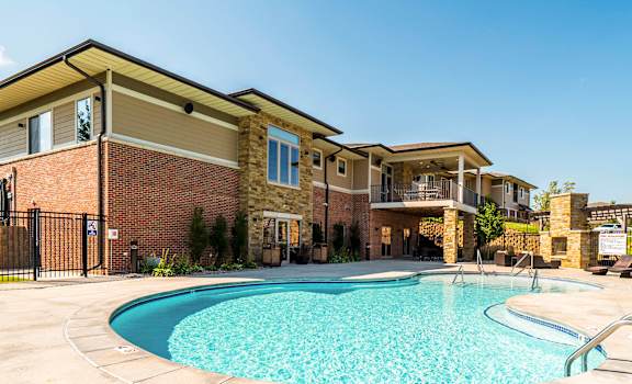 clubhouse exterior and resort style pool at The Villas of Omaha at Butler Ridge
