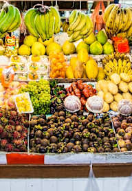 A fruit stand with a variety of fruits on display.