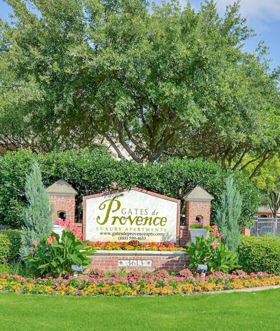 a park with a sign on the side of a street