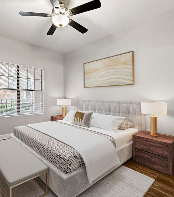 A bedroom with a bed, nightstand, and a plant at Crogman School Lofts in GA, 30315