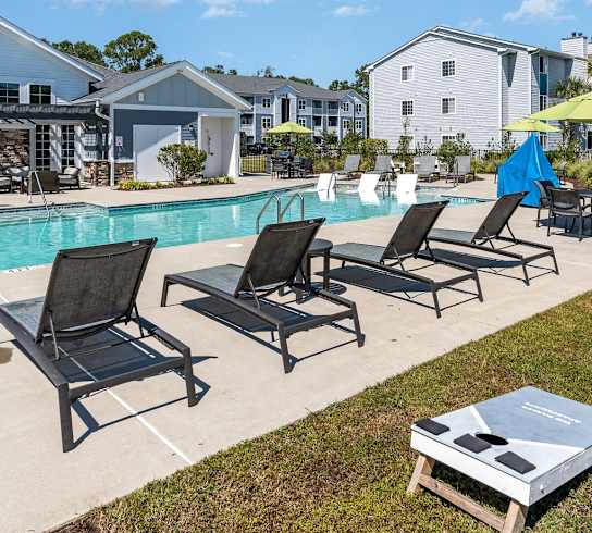 our apartments offer a swimming pool with lounge chairs and umbrellas