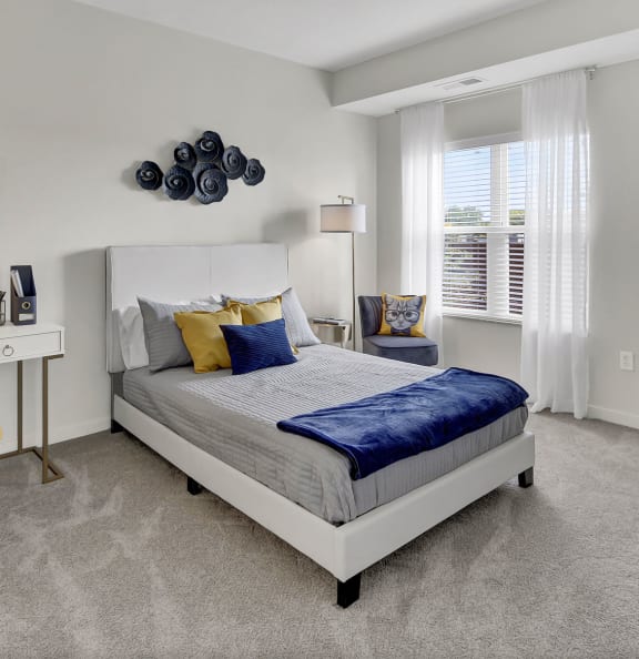 a bedroom with a bed and a desk with a chair