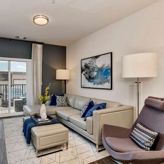 an open concept living room and dining area with a white dining table and rattan chairs