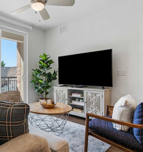 A living room with a couch, a coffee table, and a television. at City View St. George Apartments, Utah, 84770