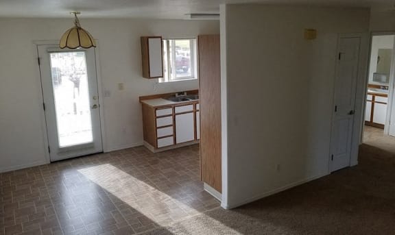 The image shows a door next to the kitchen to exit the apartment