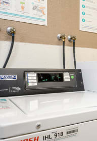 three washing machines in a laundromat