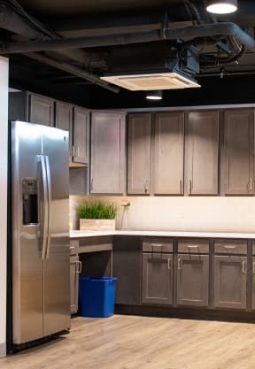 a kitchen with a stainless steel refrigerator and wooden cabinets