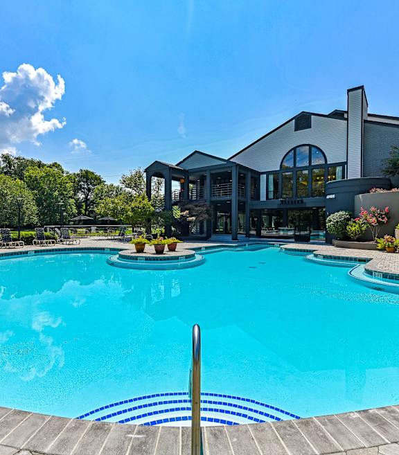 A large pool in front of a building during the day