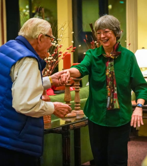two people shaking hands in a living room