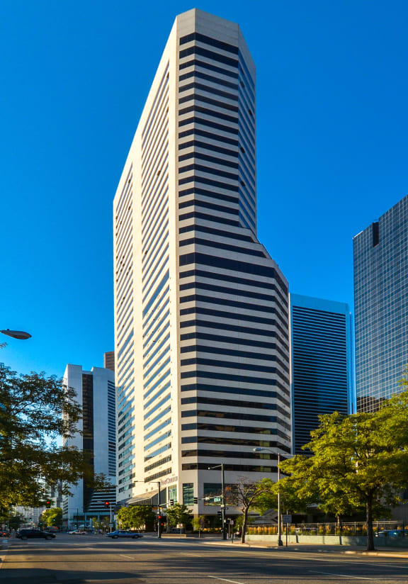 a tall skyscraper in a city with other tall buildings  at Apartments at Denver Place, Denver, 80202