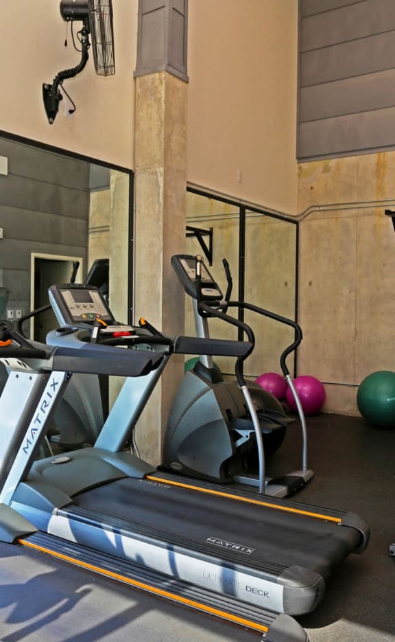 a gym with treadmills and other exercise equipment in a building  at 1221 Broadway Lofts, Texas, 78215