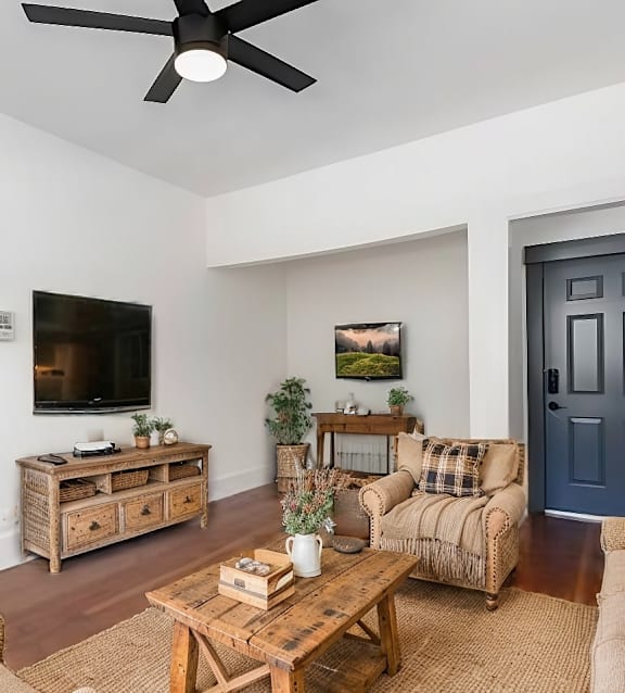 A living room with a blue door and a television.at Midtown East, Portland, OR 97209