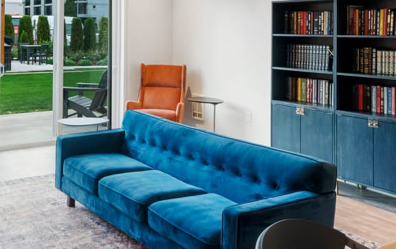 a living room with a blue couch and a table and chairs  at The Hub, Washington, 98503