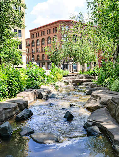 a street view of an apartment building with trees
