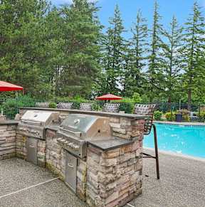 Alvista 23 Apartment Homes Clubhouse and Pool with Lounge Chairs