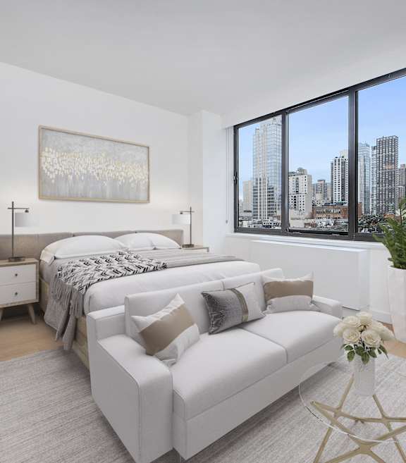 A bedroom with a large bed and a couch.at 301E94, New York, 10128