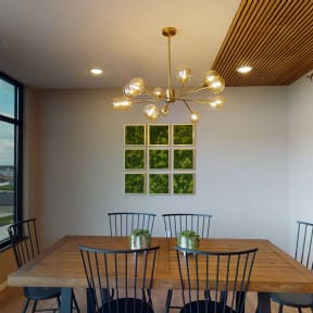 a dining room with a wooden table and chairs