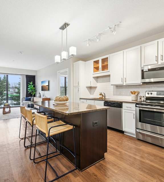 A modern kitchen with a dining table and chairs.