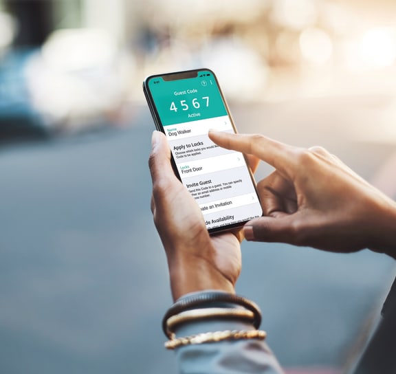 Person Holding a Smartphone with the Uber App on the Screen at Woodland Place Apartments, Midland, Michigan