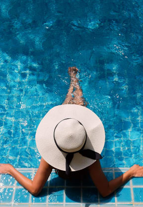 Woman Wearing Hat Sitting in Pool