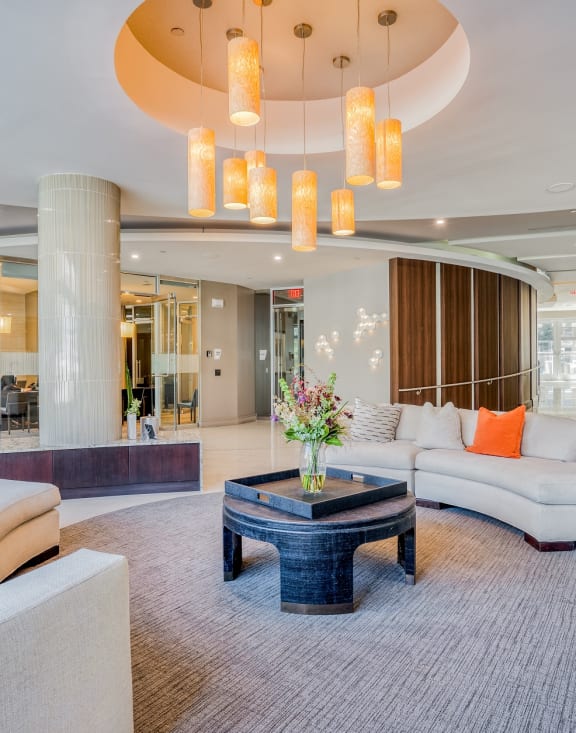 a living room filled with furniture and a large chandelier