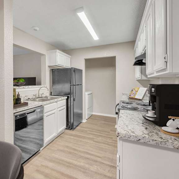 a kitchen with white appliances and wooden cabinets