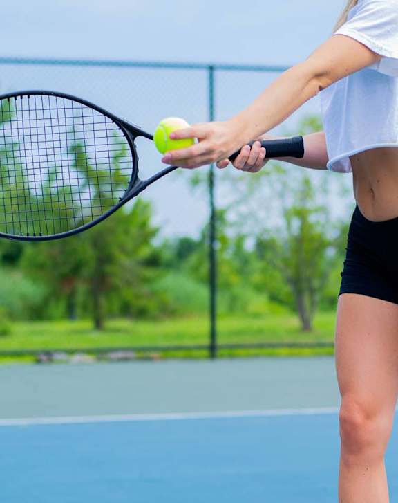 A woman playing tennis at Lofts of Wilmington, North Carolina