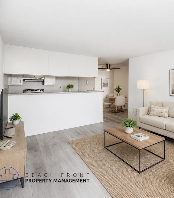 A well-lit, modern kitchen and living room with a dining area.