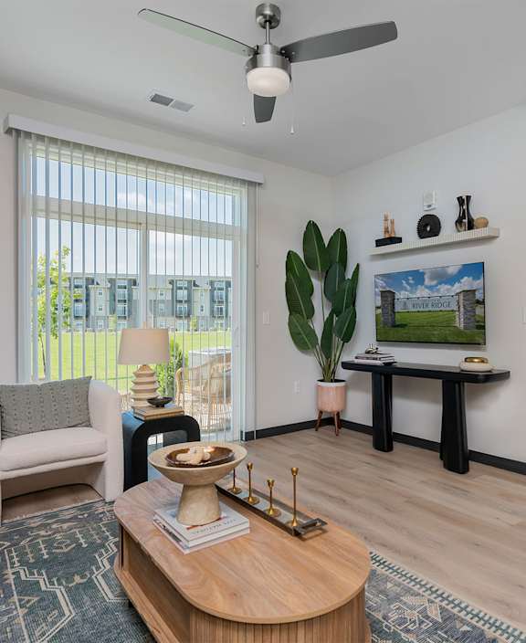 a living room with a fireplace and a couch and a rug