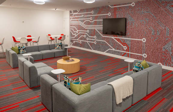 a room with couches and chairs and a wall with a television at 20 Midtown, Birmingham, AL, 35233