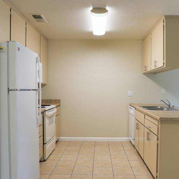 an empty kitchen and living room with a door to a patio at Creekview Homes, Chico, 95928